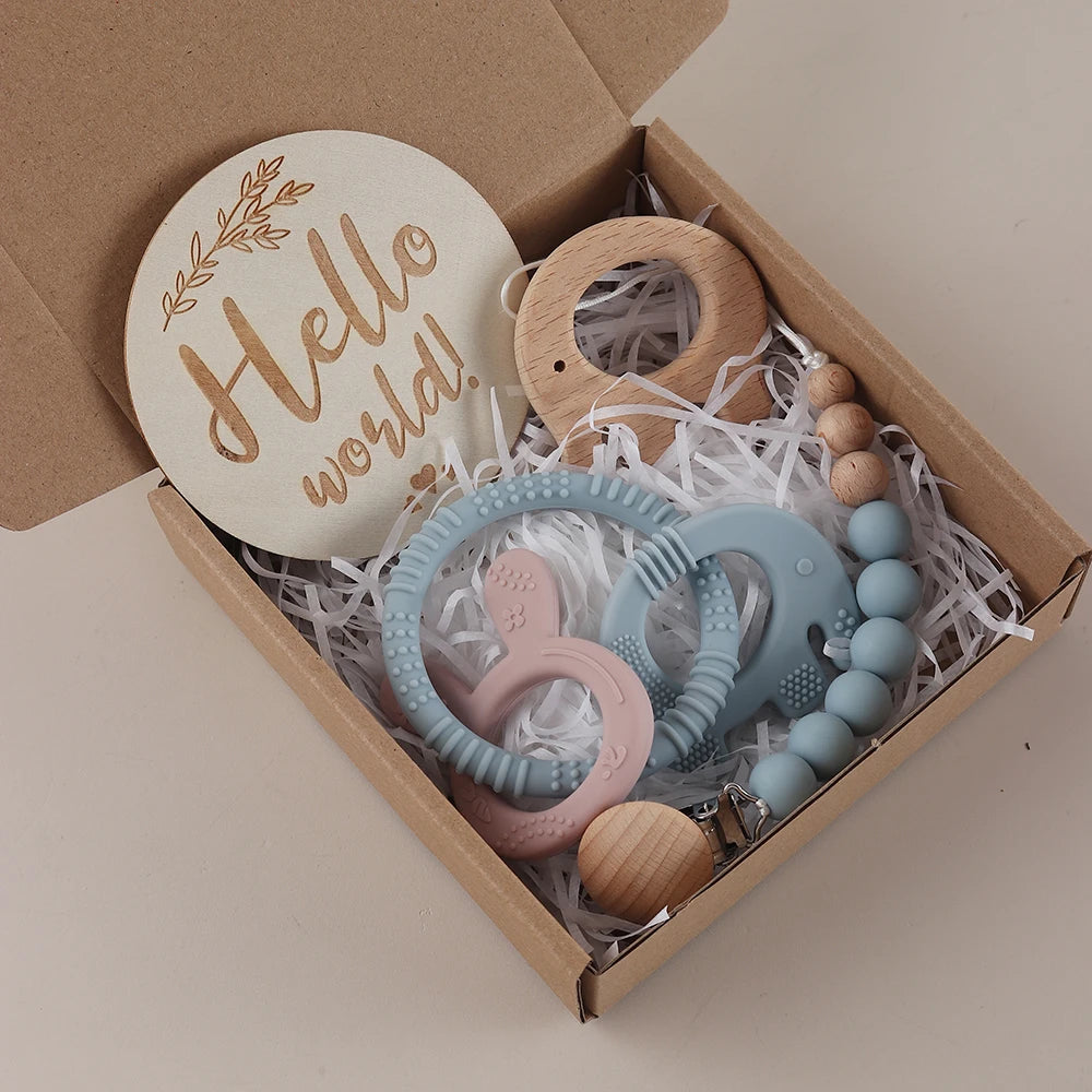Baby teething toys and 'Hello world!' disc in a cardboard box