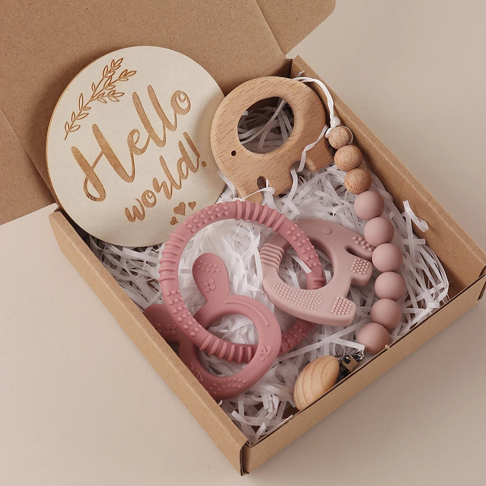 Baby teething toy set with wooden and silicone elements in a 'Hello world!' box.