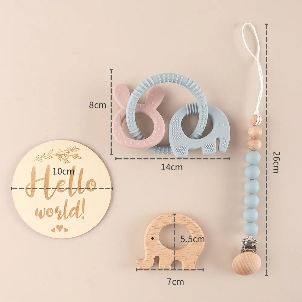 Baby teething toys with measurements on a beige background